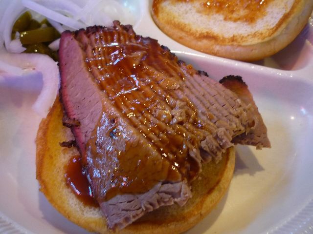 A sliced beef brisket sandwich from a Dallas barbecue joint