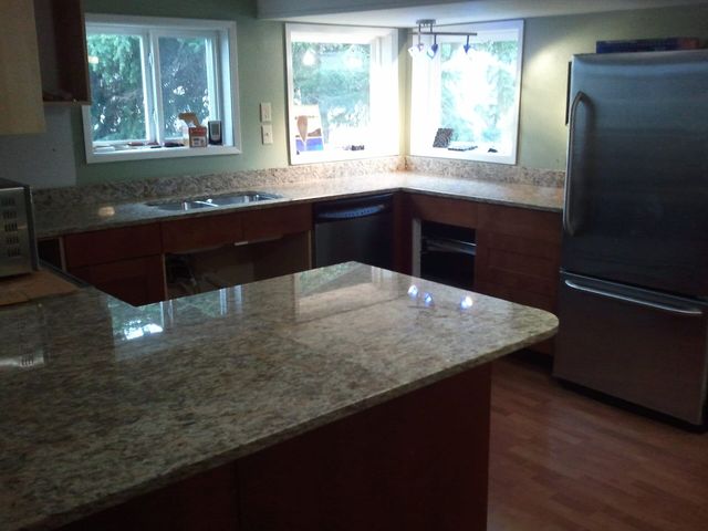 Newly installed granite countertops in a finished kitchen