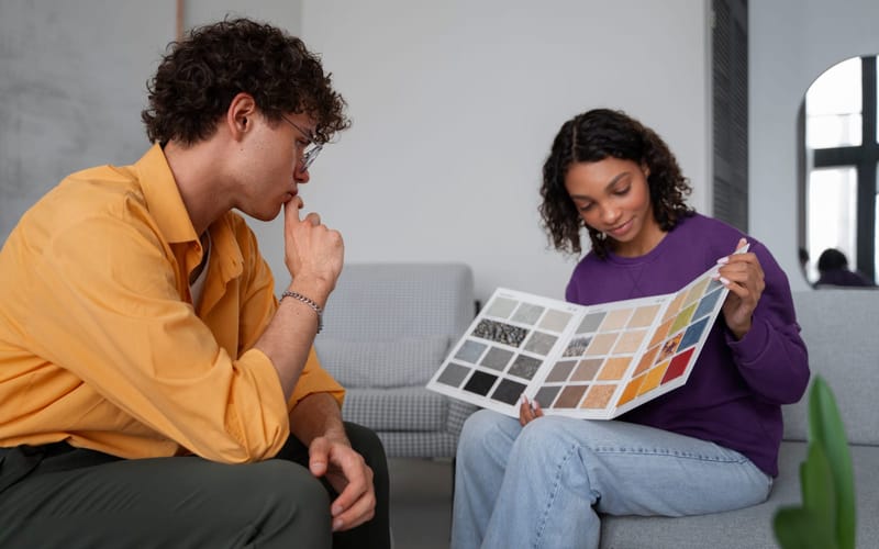 An interior designer reviewing color and material samples with a client