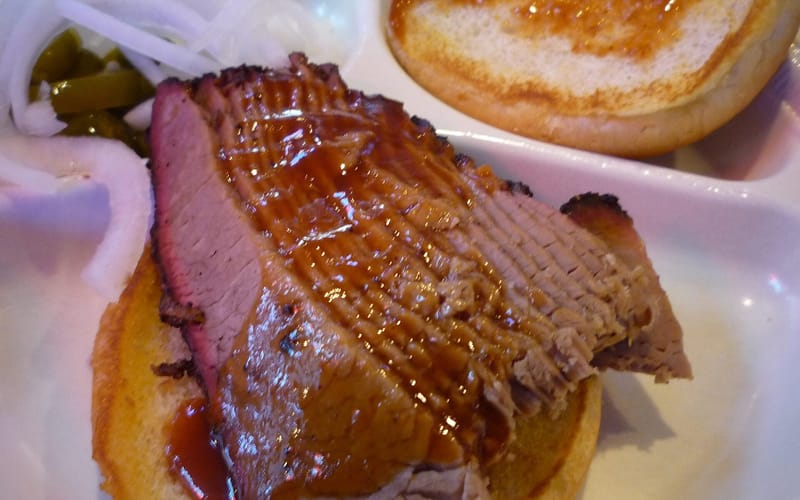 Sliced beef brisket served on a plate at a Texas barbecue joint