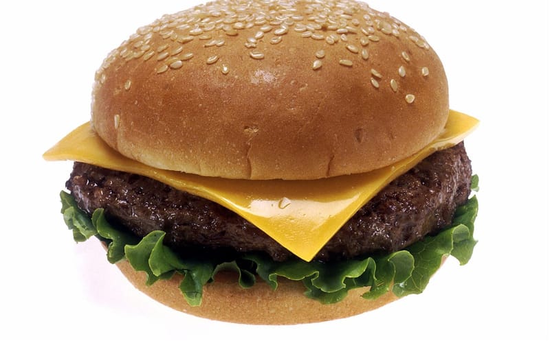 A cheeseburger with lettuce and tomato on a toasted bun