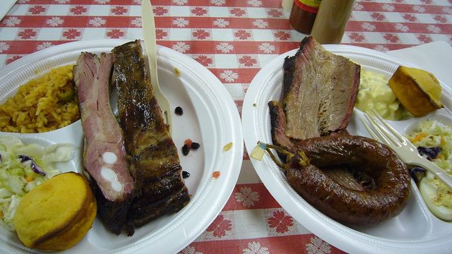 Plates of brisket, pork ribs, and sausage