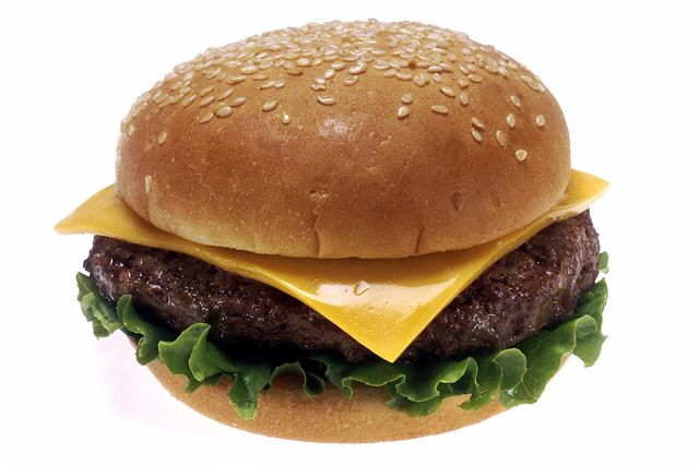 A cheeseburger with lettuce and tomato on a toasted bun