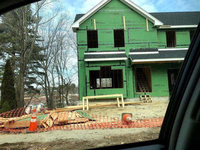 A new home under construction with framing and sheathing in place