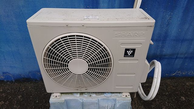 An outdoor air conditioner unit mounted outside a house